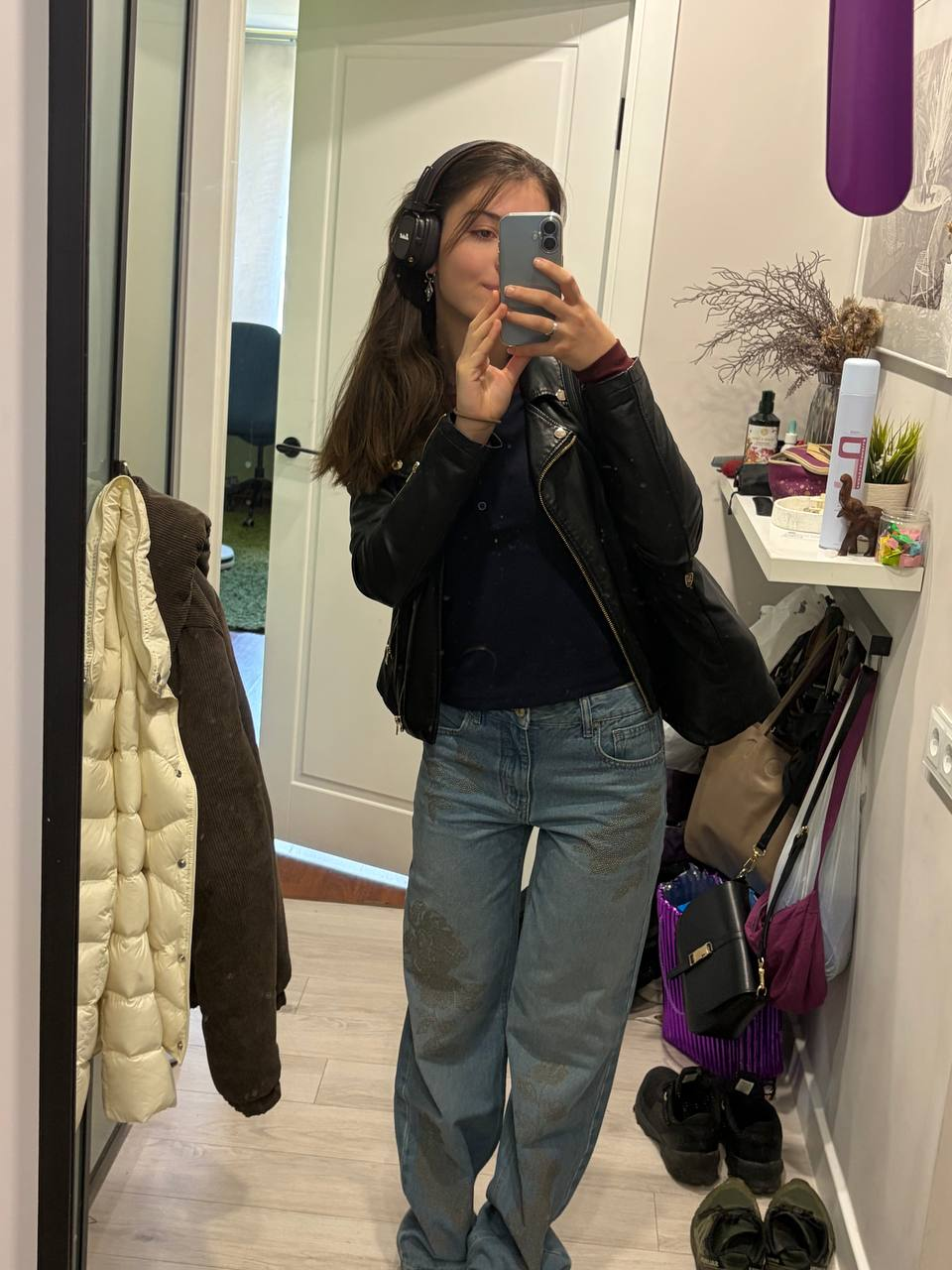 Dasha wearing headphones and a black jacket